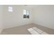 Well-lit bedroom featuring carpet and large windows at 19028 W Rose Ln, Waddell, AZ 85355