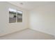 Bright bedroom featuring a large window and carpet at 19028 W Rose Ln, Waddell, AZ 85355