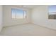 Spacious bedroom with large window and carpeted floor at 19028 W Rose Ln, Waddell, AZ 85355