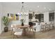 Kitchen and dining area with modern light fixture at 19028 W Rose Ln, Waddell, AZ 85355