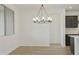 Bright dining room with chandelier and wood-look floors at 19028 W Rose Ln, Waddell, AZ 85355