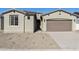 House exterior with brown garage door and gravel driveway at 19028 W Rose Ln, Waddell, AZ 85355