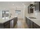 Modern kitchen with island, stainless steel appliances, and view to backyard at 19028 W Rose Ln, Waddell, AZ 85355