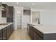 Open concept kitchen with island and walk-in pantry at 19028 W Rose Ln, Waddell, AZ 85355