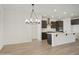 Modern kitchen with island and dark cabinetry at 19028 W Rose Ln, Waddell, AZ 85355