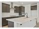 Modern kitchen with island and dark brown cabinets at 19028 W Rose Ln, Waddell, AZ 85355