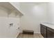 Laundry room with cabinets and overhead shelving at 19028 W Rose Ln, Waddell, AZ 85355