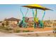 Modern playground with shade structure, slides, climbing features, and ample play space at 19028 W Rose Ln, Waddell, AZ 85355