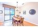 Cozy dining area with wood table and access to a patio at 19612 N Wasson Peak Dr, Surprise, AZ 85387