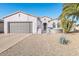 One-story home with gray garage door and desert landscaping at 19612 N Wasson Peak Dr, Surprise, AZ 85387