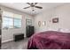 Spacious bedroom with a large bed, dresser, and window with blinds at 19690 W Marshall Ave, Litchfield Park, AZ 85340