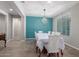 Elegant dining room with a teal accent wall and a crystal chandelier at 19690 W Marshall Ave, Litchfield Park, AZ 85340