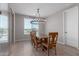 Bright dining room with a large wooden table and chandelier at 19690 W Marshall Ave, Litchfield Park, AZ 85340