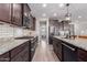 Modern kitchen with granite countertops and dark wood cabinetry at 19690 W Marshall Ave, Litchfield Park, AZ 85340