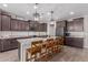 Modern kitchen featuring dark cabinetry, granite countertops, and a large island at 19690 W Marshall Ave, Litchfield Park, AZ 85340