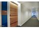 Building hallway with modern wood door and blue accent wall at 200 W Portland St # 715, Phoenix, AZ 85003