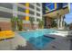 Refreshing community pool with lounge chairs and building view at 200 W Portland St # 715, Phoenix, AZ 85003