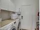 Bright laundry room with washer, dryer, and ample cabinets at 20997 N 79Th Ave, Peoria, AZ 85382