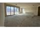 Open living room with large window and sliding glass doors at 22851 E Lords Way, Queen Creek, AZ 85142