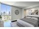 Modern bedroom with city views and dark wood floors at 2323 N Central Ave # 906, Phoenix, AZ 85004