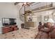 Living room with spiral staircase, TV, and tiled floor at 2333 E Southern Ave # 2041, Tempe, AZ 85282