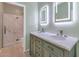 Bathroom with double vanity, marble countertops, and a walk-in shower at 2542 W Kit Carson Trl, Phoenix, AZ 85086