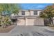 Two-story house with beige exterior, two-car garage, and mature landscaping at 2542 W Kit Carson Trl, Phoenix, AZ 85086