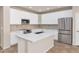 Modern kitchen with white cabinets, stainless steel appliances, and an island at 2542 W Kit Carson Trl, Phoenix, AZ 85086