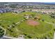 Aerial view of community park featuring baseball fields, playground, and walking paths at 29362 W Weldon Ave, Buckeye, AZ 85396