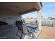 Covered patio with table and chairs, near pool at 29362 W Weldon Ave, Buckeye, AZ 85396