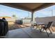 Covered patio, pool, and small table with chairs at 29362 W Weldon Ave, Buckeye, AZ 85396