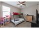 Bedroom with bunk bed, dresser, and ceiling fan at 29362 W Weldon Ave, Buckeye, AZ 85396