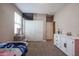 Bedroom with twin bed, dresser, and closet at 29362 W Weldon Ave, Buckeye, AZ 85396