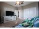 Bedroom with futon, dresser, and ceiling fan at 29362 W Weldon Ave, Buckeye, AZ 85396