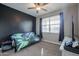 Bedroom with futon, TV, and dark-colored walls at 29362 W Weldon Ave, Buckeye, AZ 85396