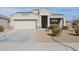 Single-story house with a two-car garage and well-manicured landscaping at 29362 W Weldon Ave, Buckeye, AZ 85396