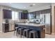 Modern kitchen with dark cabinetry, granite countertops, and an island at 29362 W Weldon Ave, Buckeye, AZ 85396