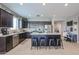 Modern kitchen with island, dark cabinets, and granite countertops at 29362 W Weldon Ave, Buckeye, AZ 85396