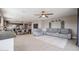 Open-concept living room with gray sectional and kitchen views at 29362 W Weldon Ave, Buckeye, AZ 85396