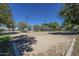 Sand volleyball court with surrounding trees and park lighting at 29362 W Weldon Ave, Buckeye, AZ 85396