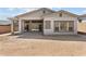 Home's backyard with covered patio and bright windows highlighting the living space at 32496 N 135Th Dr, Peoria, AZ 85383