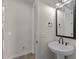 Cozy bathroom featuring stylish sink, modern fixtures, and decorative mirror at 32496 N 135Th Dr, Peoria, AZ 85383