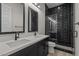Modern bathroom with dual sinks, black shower with subway tile, and sleek fixtures at 32496 N 135Th Dr, Peoria, AZ 85383