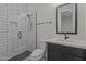 Updated bathroom featuring modern tile shower, sleek black fixtures, and vanity at 32496 N 135Th Dr, Peoria, AZ 85383