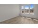 Cozy bedroom featuring wood-look tile flooring and natural light from large windows at 32496 N 135Th Dr, Peoria, AZ 85383