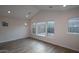 Light-filled bedroom with neutral walls, tile floors, and multiple windows overlooking the backyard at 32496 N 135Th Dr, Peoria, AZ 85383