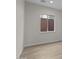 Simple bedroom with wood-look floors and a window offering natural light at 32496 N 135Th Dr, Peoria, AZ 85383