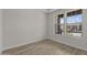 This bedroom boasts wood-look floors and two windows that bring in plenty of natural light at 32496 N 135Th Dr, Peoria, AZ 85383