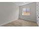 Bright bedroom with wood-look floors and a window to bring in natural light at 32496 N 135Th Dr, Peoria, AZ 85383