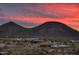 Community clubhouse and pool with scenic mountain backdrop at sunset at 32496 N 135Th Dr, Peoria, AZ 85383